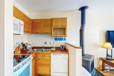 a kitchen with wooden cabinets and a sink at Timber Ridge 504B in Silverthorne