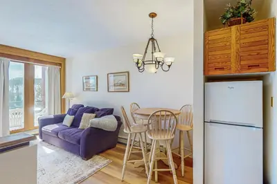 a kitchen and living room with a purple couch and a table at Timber Ridge 504B in Silverthorne