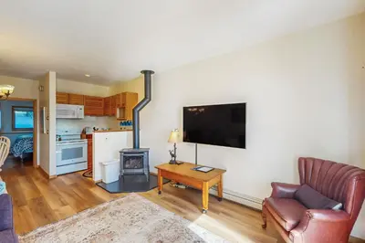 a living room with a couch and a tv on a wall at Timber Ridge 504B in Silverthorne