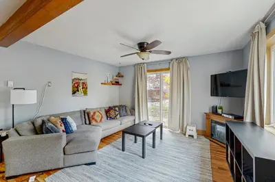 a living room with a couch and a tv at Mountains & Main Street in Frisco