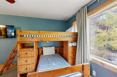 a bedroom with two bunk beds and a window at Mountains & Main Street in Frisco