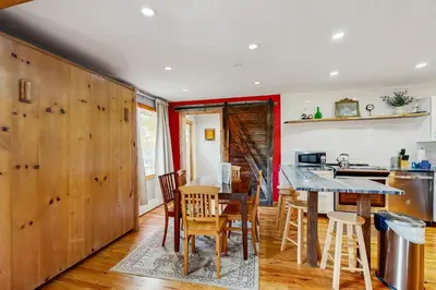 a kitchen with wooden walls and a table and chairs at Mountains & Main Street in Frisco