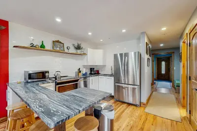 a kitchen with a marble counter top in it at Mountains & Main Street in Frisco
