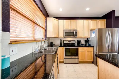 a kitchen with wooden cabinets and stainless steel appliances at 97A Exceptional Views, 4 BR, Central Location in Silverthorne