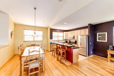 a kitchen and dining room with a table and chairs at 97A Exceptional Views, 4 BR, Central Location in Silverthorne