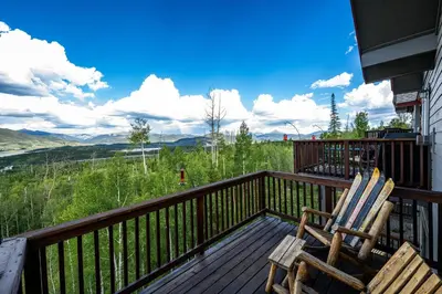 two chairs sitting on a deck with a view at 97A Exceptional Views, 4 BR, Central Location in Silverthorne