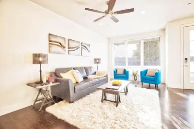 a living room with a gray couch and blue chairs at Beautiful 3 Bedroom Townhouse in Old Town North, Brewery District in Fort Collins