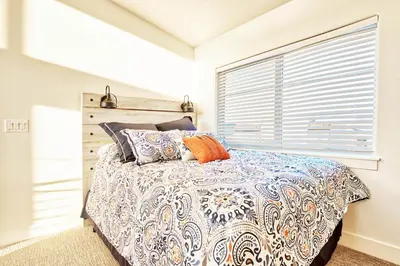 a bedroom with a bed and a window at Beautiful 3 Bedroom Townhouse in Old Town North, Brewery District in Fort Collins