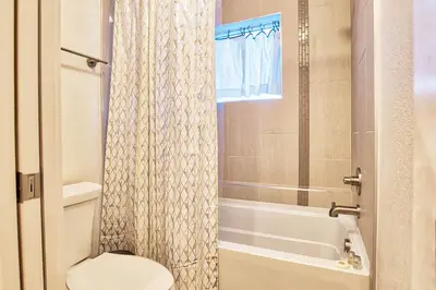 a bathroom with a toilet and a tub and a shower at Beautiful 3 Bedroom Townhouse in Old Town North, Brewery District in Fort Collins
