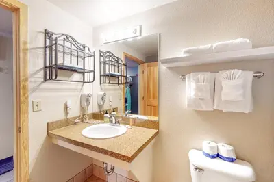 a bathroom with a sink and a toilet and a mirror at Gateway 5079 in Keystone