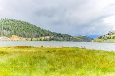 a field of grass next to a body of water at Gateway 5079 in Keystone