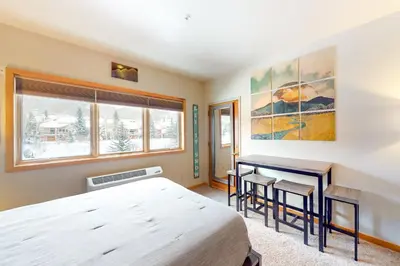 a bedroom with a bed and a desk at Gateway 5079 in Keystone