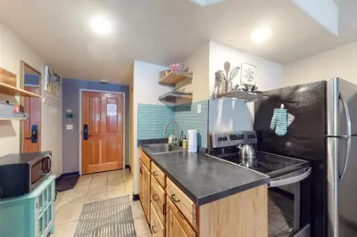 a kitchen with a sink and a refrigerator at Gateway 5079 in Keystone