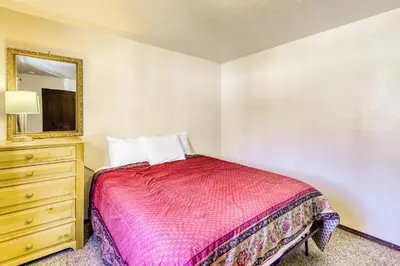 a bedroom with a bed and a dresser and a mirror at Straight Creek Sanctuary in Dillon