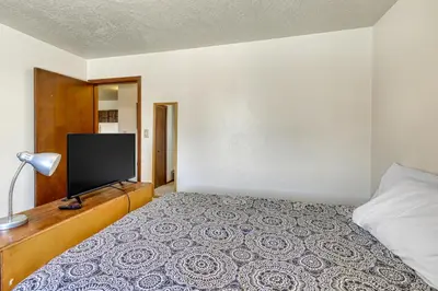 a bedroom with a bed with a flat screen tv at Straight Creek Sanctuary in Dillon