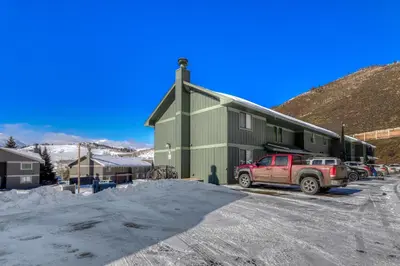 a red truck parked in front of a green building at Straight Creek Sanctuary in Dillon
