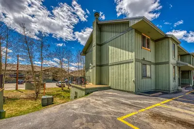 a green building in a parking lot at Straight Creek Sanctuary in Dillon