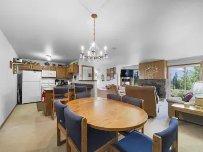 a kitchen and living room with a wooden table and chairs at Bb103 Buffalo Village 2Br 2Ba Condo in Silverthorne