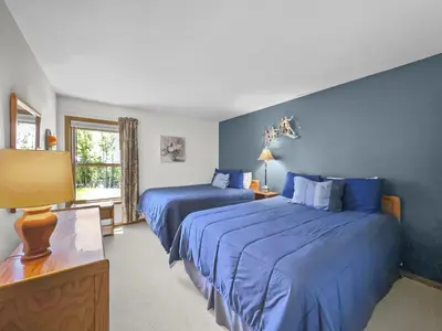 two beds in a room with blue walls at Bb103 Buffalo Village 2Br 2Ba Condo in Silverthorne