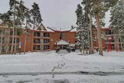 a large brick building with snow on the ground at Bb103 Buffalo Village 2Br 2Ba Condo in Silverthorne