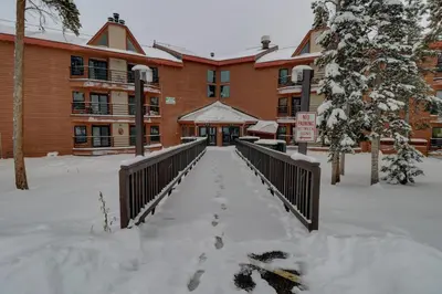 a building covered in snow with footprints in the snow at Bb103 Buffalo Village 2Br 2Ba Condo in Silverthorne