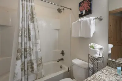 a bathroom with a tub and a toilet and a shower at Trailhead Lodges Building 401 Unit 422 in Winter Park