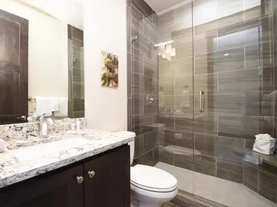 a bathroom with a toilet and a glass shower at Arrow at Winter Park Unit 284 in Winter Park