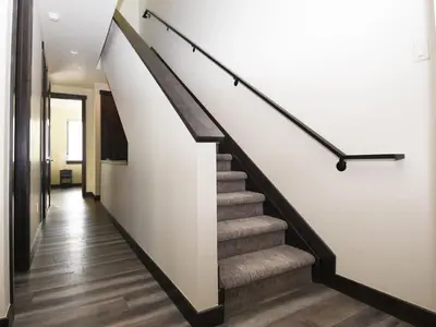 a staircase in a home with white walls and wooden floors at Arrow at Winter Park Unit 284 in Winter Park