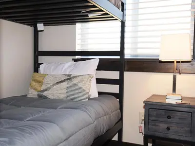 a bedroom with a bed and a lamp on a night stand at Arrow at Winter Park Unit 284 in Winter Park