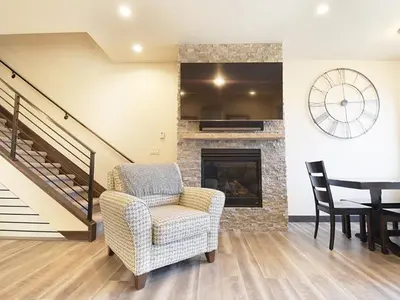 a living room with a chair and a fireplace at Arrow at Winter Park Unit 284 in Winter Park