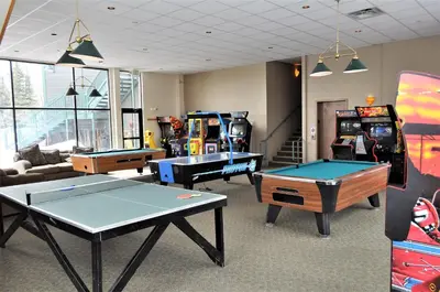 a room with ping pong tables and arcade games at Treehouse 2 bed 2 bath C THWC in Silverthorne