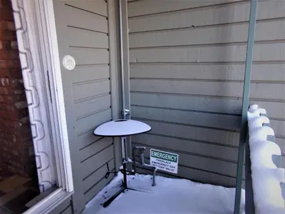a small table sitting in the snow next to a house at Treehouse 2 bed 2 bath C THWC in Silverthorne