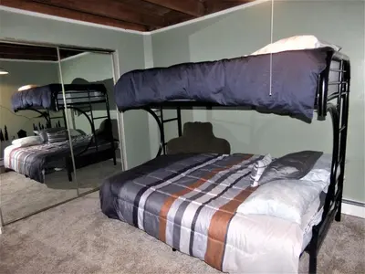 a bedroom with two bunk beds and a mirror at Treehouse 2 bed 2 bath C THWC in Silverthorne
