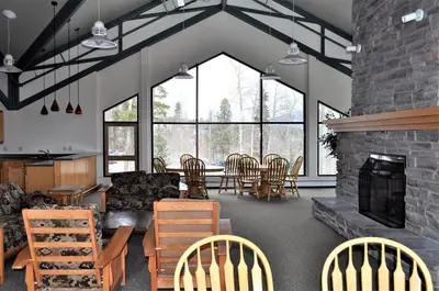 a living room with a fireplace and a table and chairs at Treehouse 2 bed 2 bath C THWC in Silverthorne