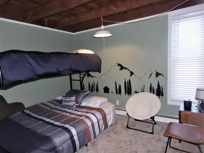 a bedroom with a bunk bed and a chair at Treehouse 2 bed 2 bath C THWC in Silverthorne