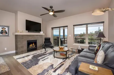 a living room with a couch and a fireplace at Rendezvous 47 Lookout Point in Fraser