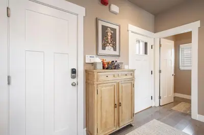a hallway with a door and a wooden cabinet at Rendezvous 47 Lookout Point in Fraser