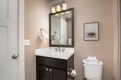 a bathroom with a sink and a toilet and a mirror at Rendezvous 47 Lookout Point in Fraser