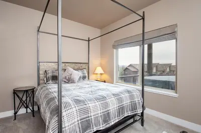 a bedroom with a canopy bed and a window at Rendezvous 47 Lookout Point in Fraser