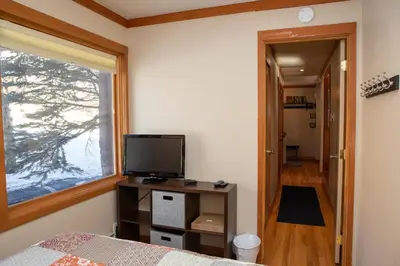 a bedroom with a bed and a television and a window at 1320 Tennis Townhome Townhouse in Keystone