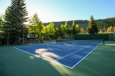 a tennis court with a net on it at 1320 Tennis Townhome Townhouse in Keystone