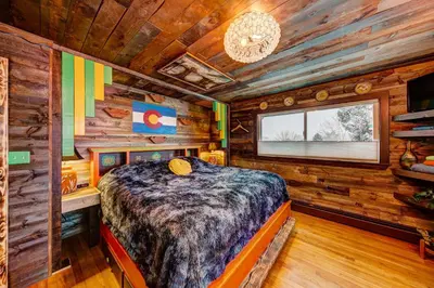 a bedroom with a bed in a log cabin at The Oasis on Eisenhower in Loveland