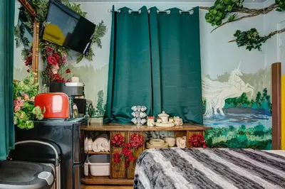 a bedroom with a bed and a green curtain at The Oasis on Eisenhower in Loveland