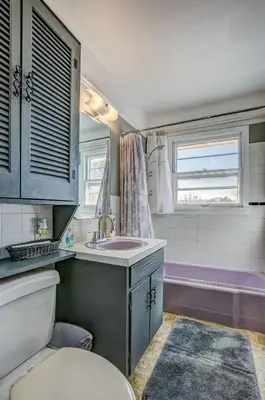 a bathroom with a toilet and a sink and a tub at The Oasis on Eisenhower in Loveland
