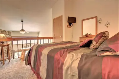 a bedroom with two beds and a table and a mirror at Dd402E Buffalo Village Studio Condo in Silverthorne