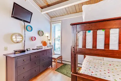 a bedroom with a bunk bed and a dresser at Lodgepole Treehouse & Treehouse Serenity in Silverthorne