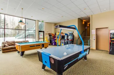 a living room with a pool table in it at Lodgepole Treehouse & Treehouse Serenity in Silverthorne