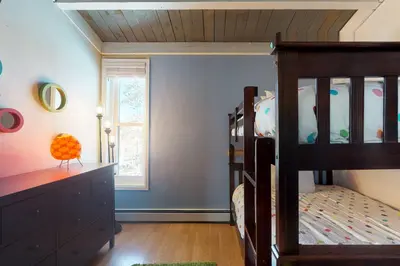 a childs bedroom with a bunk bed and a dresser at Lodgepole Treehouse & Treehouse Serenity in Silverthorne