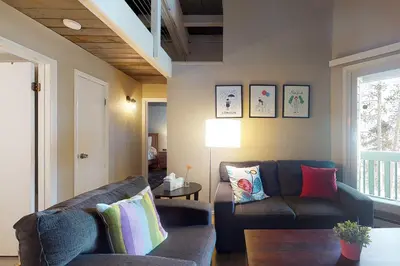 a living room with a couch and a table at Lodgepole Treehouse & Treehouse Serenity in Silverthorne