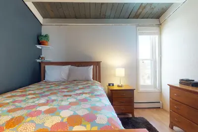 a bedroom with a bed and a dresser and a window at Lodgepole Treehouse & Treehouse Serenity in Silverthorne